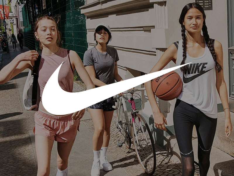 Girls wearing Nike apparel waking down a street.