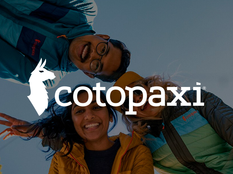 Cotopaxi logo over and image of three friends wearing Cotopaxi jackets smiling and looking down at the camera.